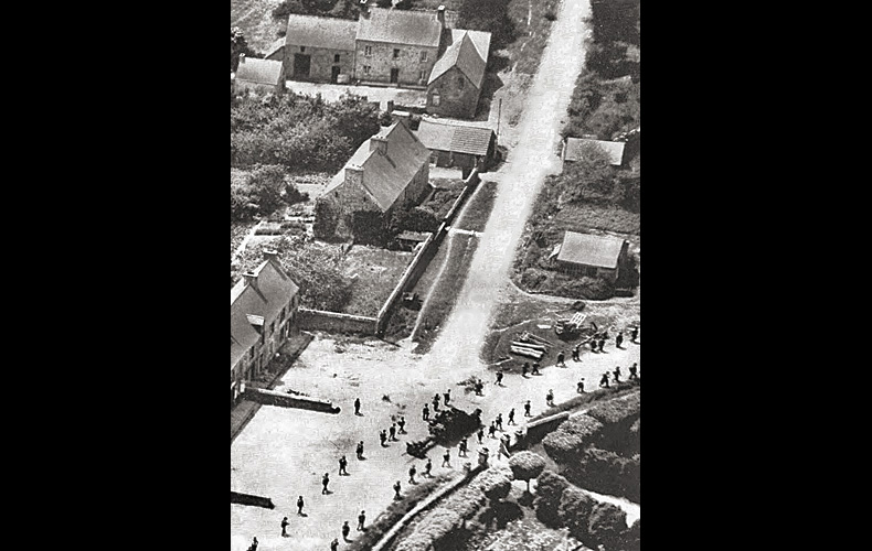 The 39th Infantry Division passes through Saint-Jacques-de-Nehouh after an attempted German breakthrough was repulsed on the morning of June 18th.
